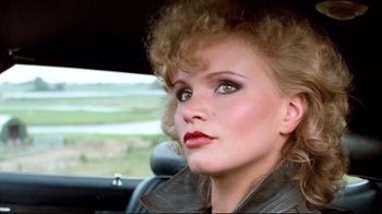 Movie still from “Spetters” (1980), directed by Paul Verhoeven – A person sitting in a car; Close Up shot, Low angle