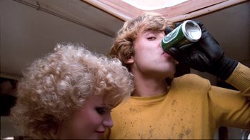 Movie still from “Spetters” (1980), directed by Paul Verhoeven – A man and a woman are drinking a beer; Close Up shot, Low angle