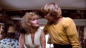 Movie still from “Spetters” (1980), directed by Paul Verhoeven – A man and a woman talking to each other; Medium shot, Low angle