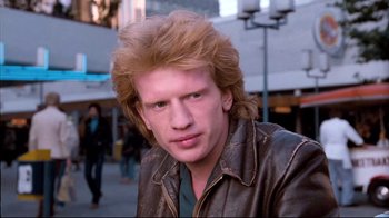 Movie still from “Spetters” (1980), directed by Paul Verhoeven – A young man with red hair is posing for a picture; Close Up shot, Low angle