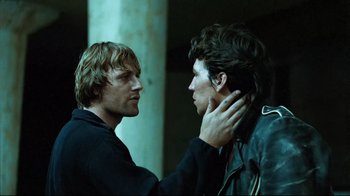 Movie still from “Spetters” (1980), directed by Paul Verhoeven – Two young men standing next to each other; Close Up shot, Over the shoulder angle