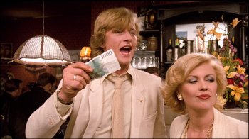 Movie still from “Spetters” (1980), directed by Paul Verhoeven – A young man holding a bunch of money in his hand; Close Up shot, Low angle