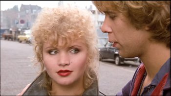 Movie still from “Spetters” (1980), directed by Paul Verhoeven – A man and a woman standing next to each other on the street; Close Up shot, Over the shoulder angle