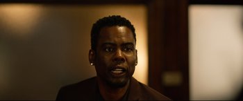 Movie still from “Spiral” (2021), directed by Darren Lynn Bousman – A person wearing a jacket; Close Up shot, Over the shoulder angle