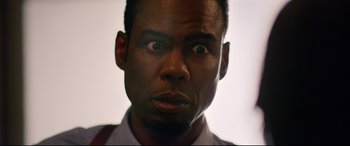 Movie still from “Spiral” (2021), directed by Darren Lynn Bousman – A man's face with a surprised look on his face; Close Up shot, Low angle
