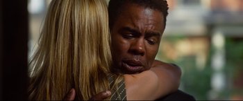 Movie still from “Spiral” (2021), directed by Darren Lynn Bousman – A man and a woman are hugging and crying; Close Up shot, Over the shoulder angle