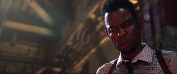 Movie still from “Spiral” (2021), directed by Darren Lynn Bousman – A person wearing a shirt and tie; Close Up shot, Low angle