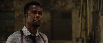 Movie still from “Spiral” (2021), directed by Darren Lynn Bousman – A man in a plaid shirt is looking at the camera; Close Up shot, Over the shoulder angle