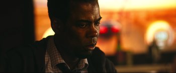 Movie still from “Spiral” (2021), directed by Darren Lynn Bousman – A man's face in the sunlight; Close Up shot, Over the shoulder angle