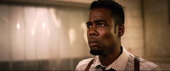 Movie still from “Spiral” (2021), directed by Darren Lynn Bousman – A person wearing a shirt and tie; Close Up shot, Low angle