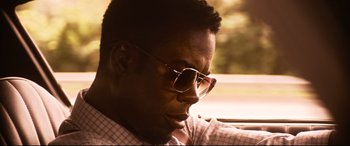 Movie still from “Spiral” (2021), directed by Darren Lynn Bousman – A person wearing glasses in a car; Close Up shot, Low angle