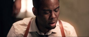 Movie still from “Spiral” (2021), directed by Darren Lynn Bousman – A person wearing a shirt and a tie; Close Up shot, Over the shoulder angle