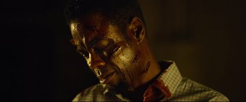 Movie still from “Spiral” (2021), directed by Darren Lynn Bousman – A person with blood all over his face; Close Up shot, Low angle