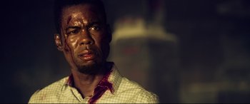 Movie still from “Spiral” (2021), directed by Darren Lynn Bousman – A person wearing a plaid shirt; Close Up shot, Low angle