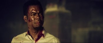 Movie still from “Spiral” (2021), directed by Darren Lynn Bousman – A person with blood on his face; Close Up shot, Low angle
