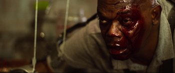 Movie still from “Spiral” (2021), directed by Darren Lynn Bousman – A person with blood on his face; Close Up shot, Low angle
