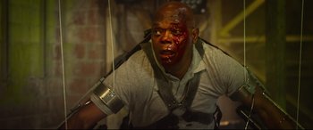 Movie still from “Spiral” (2021), directed by Darren Lynn Bousman – A man with blood all over his face and neck; Medium shot, Low angle