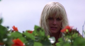 Movie still from “Splash” (1983), directed by Ron Howard – A woman with blonde hair looking at the camera; Close Up shot, Low angle