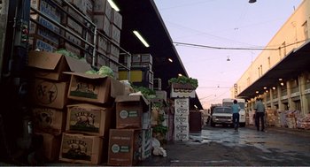 Movie still from “Splash” (1983), directed by Ron Howard – A lot of boxes of food on the street; Extreme Wide shot, Low angle