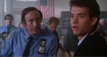 Movie still from “Splash” (1983), directed by Ron Howard – Two men in uniform are looking at each other; Close Up shot, Over the shoulder angle