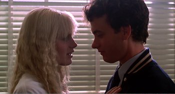 Movie still from “Splash” (1983), directed by Ron Howard – A man and a woman face to face in front of a window; Close Up shot, Low angle