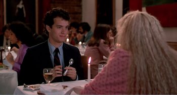 Movie still from “Splash” (1983), directed by Ron Howard – A man sitting at a dinner table with a spoon in his hand; Medium shot, Over the shoulder angle