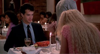 Movie still from “Splash” (1983), directed by Ron Howard – A man sitting at a dinner table with a lobster; Medium shot, Over the shoulder angle