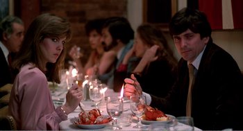 Movie still from “Splash” (1983), directed by Ron Howard – A group of people sitting at a dinner table; Medium shot, Over the shoulder angle
