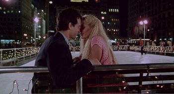 Movie still from “Splash” (1983), directed by Ron Howard – A man and a woman kissing on a railing in a city; Medium shot, High angle
