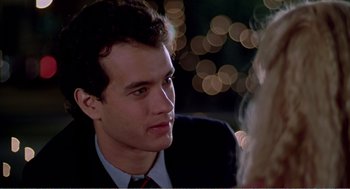 Movie still from “Splash” (1983), directed by Ron Howard – A man in a suit and tie talking to a woman in a dress; Close Up shot, Over the shoulder angle