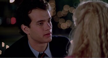 Movie still from “Splash” (1983), directed by Ron Howard – A man in a suit and tie talking to a woman in a suit; Close Up shot, Over the shoulder angle