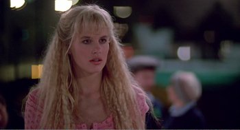 Movie still from “Splash” (1983), directed by Ron Howard – A woman with long blonde hair wearing a pink shirt; Close Up shot, Low angle
