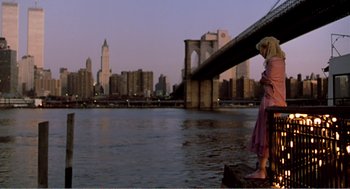 Movie still from “Splash” (1983), directed by Ron Howard – A woman standing on a rock near a body of water; Wide shot, Low angle