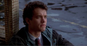 Movie still from “Splash” (1983), directed by Ron Howard – A man in a tie sitting on the ground; Close Up shot, Low angle