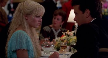 Movie still from “Splash” (1983), directed by Ron Howard – Two people sitting at a table with a glass of wine; Medium shot, Over the shoulder angle