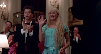 Movie still from “Splash” (1983), directed by Ron Howard – A woman with long blonde hair waving at a crowd; Medium shot, Low angle