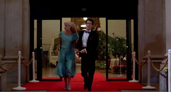 Movie still from “Splash” (1983), directed by Ron Howard – A man and a woman walking down a red carpet; Wide shot, Low angle