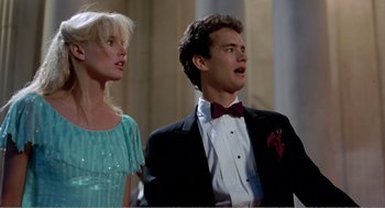 Movie still from “Splash” (1983), directed by Ron Howard – A man and a woman in formal wear singing; Medium shot, Low angle