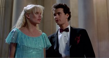 Movie still from “Splash” (1983), directed by Ron Howard – A man and a woman standing next to each other in formal wear; Medium shot, Low angle