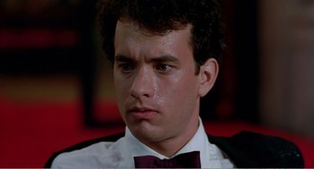 Movie still from “Splash” (1983), directed by Ron Howard – A person wearing a suit and bow tie; Close Up shot, Low angle