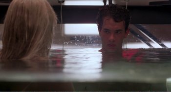 Movie still from “Splash” (1983), directed by Ron Howard – A man and a woman in the water in a room; Medium shot, Over the shoulder angle