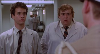 Movie still from “Splash” (1983), directed by Ron Howard – Two men in white lab coats looking at the camera; Close Up shot, Low angle
