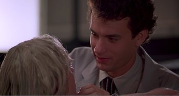 Movie still from “Splash” (1983), directed by Ron Howard – A man in a suit and tie talking to a woman in a tie; Close Up shot, Over the shoulder angle