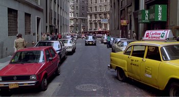 Movie still from “Splash” (1983), directed by Ron Howard – A street filled with lots of parked cars on the side of the road; Extreme Wide shot, High angle