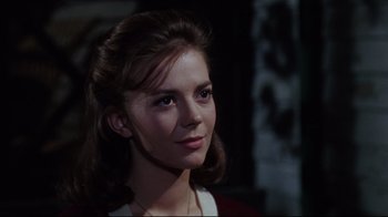 Movie still from “Splendor in the Grass” (1961), directed by Elia Kazan – A young woman with brown hair wearing a red shirt; Close Up shot, Over the shoulder angle