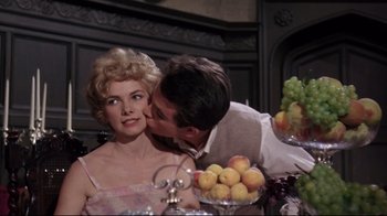 Movie still from “Splendor in the Grass” (1961), directed by Elia Kazan – A man kissing a woman on the forehead; Close Up shot, Over the shoulder angle