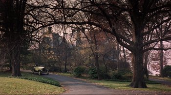 Movie still from “Splendor in the Grass” (1961), directed by Elia Kazan – A car driving down a road in a wooded area; Extreme Wide shot, High angle