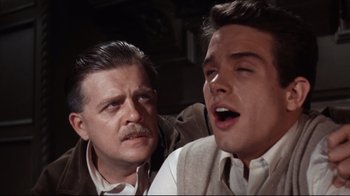 Movie still from “Splendor in the Grass” (1961), directed by Elia Kazan – Two men are standing next to each other; Close Up shot, Low angle