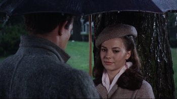 Movie still from “Splendor in the Grass” (1961), directed by Elia Kazan – A man and a woman under an open umbrella; Close Up shot, Over the shoulder angle