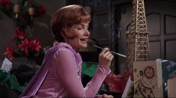 Movie still from “Splendor in the Grass” (1961), directed by Elia Kazan – A woman in a purple shirt is painting a picture; Medium shot, Low angle
